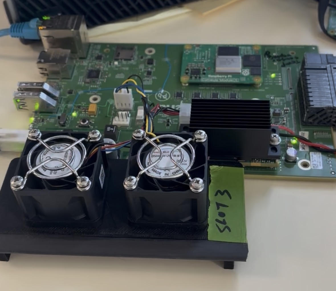Raspberry Pi test board connected to a dual-fan fixture for RPM measurement